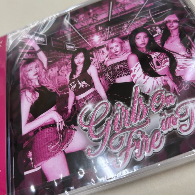 Pink-themed K-pop album or merchandise packaging for 'Girls on Fire' featuring five female artists in a stylized pink photo spread.