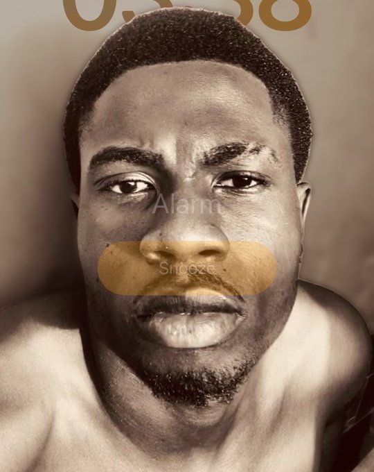 A sepia-toned close-up selfie of a shirtless man with a serious expression, overlaid with an iPhone "Alarm" screen showing "6:36" and a gold "Snooze" button, likely depicting an early morning wake-up to start the day with a cheerful "Gm" (good morning) greeting.