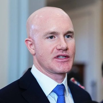 The image features a bald man wearing a suit, tie, and white shirt with blue collar. He has a serious expression as he looks off into the distance. The caption reads "THIS IS BIG: Brian Armstrong says you can now instantly borrow USDC against $XRP". This statement is related to the post because it suggests that Brian Armstrong, who is known for his role in cryptocurrency and digital currency, is offering a way for people to borrow USDC (United States Dollar Coin) against Bitcoin.

The image also includes other elements such as a person's face and a building in the background. The presence of these details helps create an overall atmosphere that connects Brian Armstrong with the concept of lending USDC against Bitcoin.