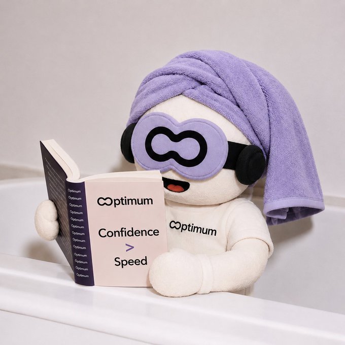 A plush toy character wearing a purple towel and infinity-symbol sunglasses reading a book titled 'Optimum: Confidence > Speed'.