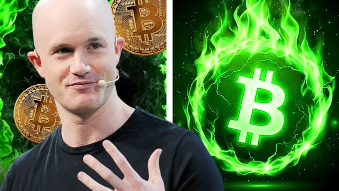 A bald man (Brian Armstrong) gesturing in front of a green flame Bitcoin logo with physical Bitcoin coins in the background.