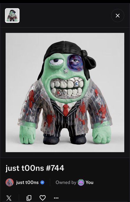 A 3D digital collectible figure called 'just t00ns #744' featuring a green-skinned character with a large toothy mouth, displayed in a marketplace interface indicating it's owned by the user.