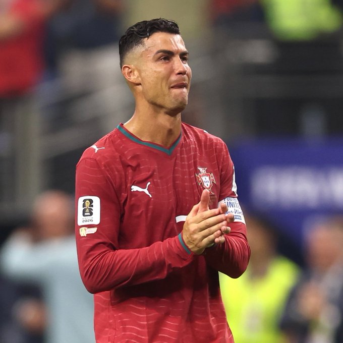 Cristiano Ronaldo, wearing a Portugal national team jersey with "2016" World Cup Qualifier patch, appears visibly emotional while clapping on the pitch. His teary expression aligns with the post about him holding back tears after Portugal's loss to Spain, which sent the Polymarket odds on "Will Ronaldo cry at the World Cup?" sharply toward No (85%) over Yes (15%).