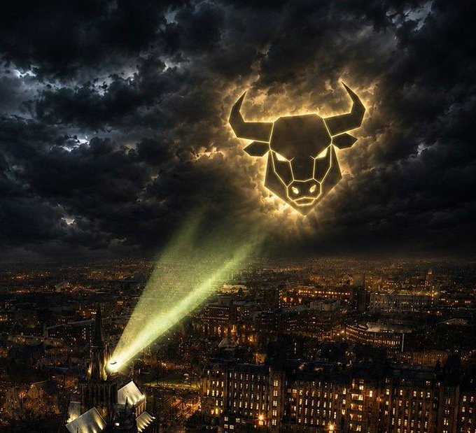 A dramatic digital composite showing a glowing bull's head logo (resembling the Chicago Bulls) projected from a cathedral spire into stormy clouds above a city skyline at night.