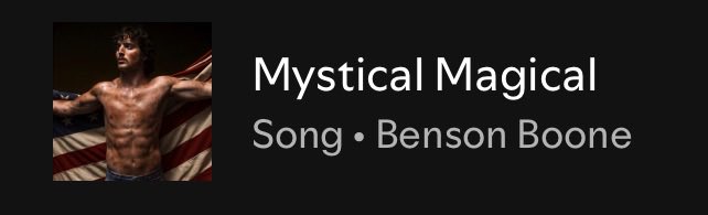 An album/track display showing a shirtless man with an American flag, with the text 'Mystical Magical Song • Benson Boone' on a black background.