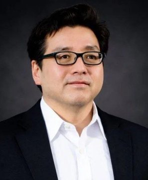 A professional headshot of Tom Lee, the fund manager known for his bullish Ethereum outlook, shown in glasses and a dark blazer. The image accompanies news of his firm BitMine's $68 million ETH purchase, marking 63 consecutive weeks of Ethereum accumulation.
