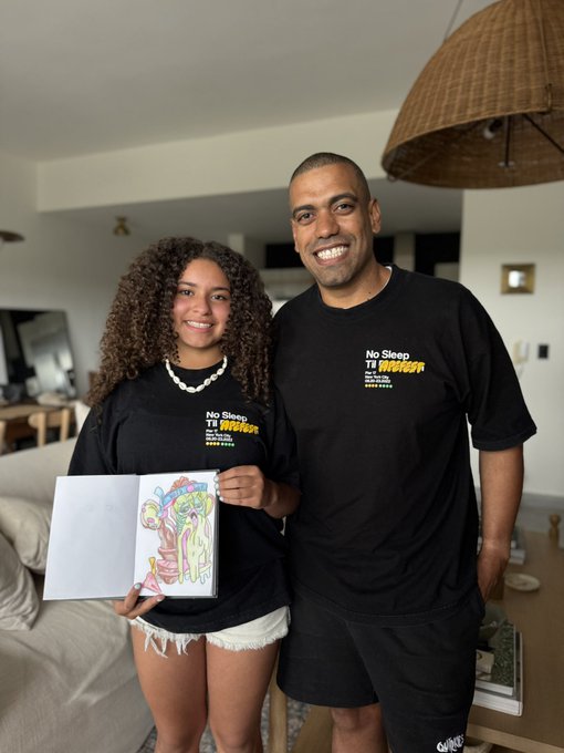 A smiling man and his niece pose together wearing matching black "No Sleep Til Tulum" t-shirts from ApeFest, with the niece proudly displaying her colorful hand-drawn artwork of his Mutant Ape Yacht Club (MAYC) NFT. The image captures the family moment referenced in the post, showcasing both the girl's creative interpretation of the NFT and the matching event merchandise.
