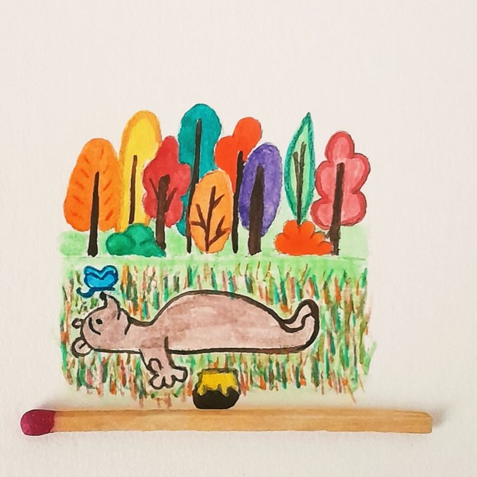 A colorful child's marker drawing of a pink creature in a field with multicolored trees, accompanied by a blue bird and a small yellow pot, with a wooden matchstick placed below it.