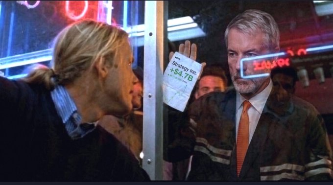 A man in a suit with an orange tie holds a paper reading "Strategy Inc. +$4.7B" against a window, confronting another man outside, in a scene that mirrors the "How do you like them apples?" moment with a financial twist showing a massive gain for the ticker MSTR (Strategy Inc., formerly MicroStrategy).