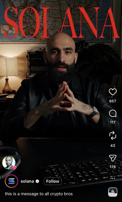 The image features a man with a beard sitting at a desk, wearing a leather jacket. The background includes a map and a keyboard, suggesting that this might be an office setting or a workspace. There are also some text elements in the image, such as "BREAKING" and "@mert Co-Founder of Solana". These elements seem to be related to the post about the man with the beard sitting at his desk. The caption reads: "BREAKING: @mert Co-Founder of Solana warns all crypto bros, he's coming for their jobs!".