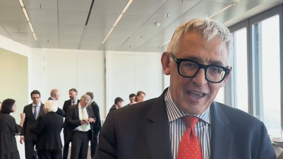 The image shows a man wearing glasses, standing in front of a group of people who are also wearing suits. The man has his hands together and appears to be smiling at the camera. In the background, there is another person dressed in a suit as well. The scene takes place in an office setting with a window visible behind the group.

The image includes text that reads "Say no to CBCD'S. Say no to the digital Euro. Say yes to bitcoin". This message seems to be related to Bitcoin, which is a type of cryptocurrency. It could be a promotional post or advertisement for Bitcoin, but it's not clear from the image alone whether this is the case.