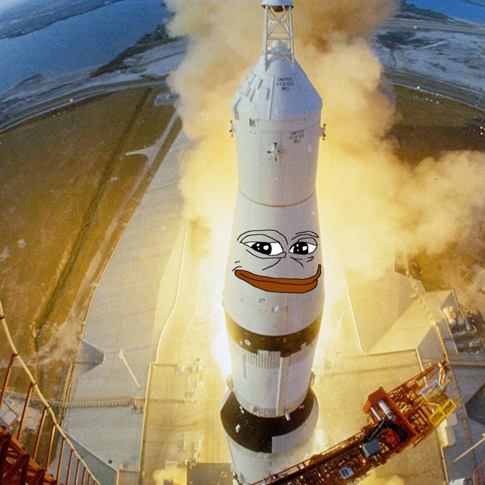 A digitally edited image showing a NASA Saturn V rocket launching, with a smug Pepe the Frog face crudely drawn onto its side amidst billowing smoke and flames.