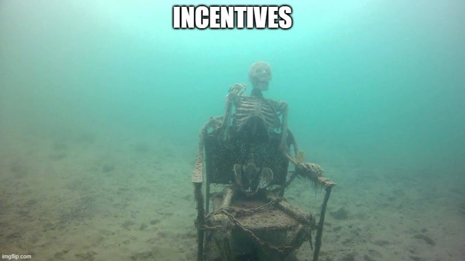 A meme image showing an underwater skeleton sitting in a chair with chains wrapped around it, captioned "INCENTIVES" in white text at the top, watermarked imgflip.com.