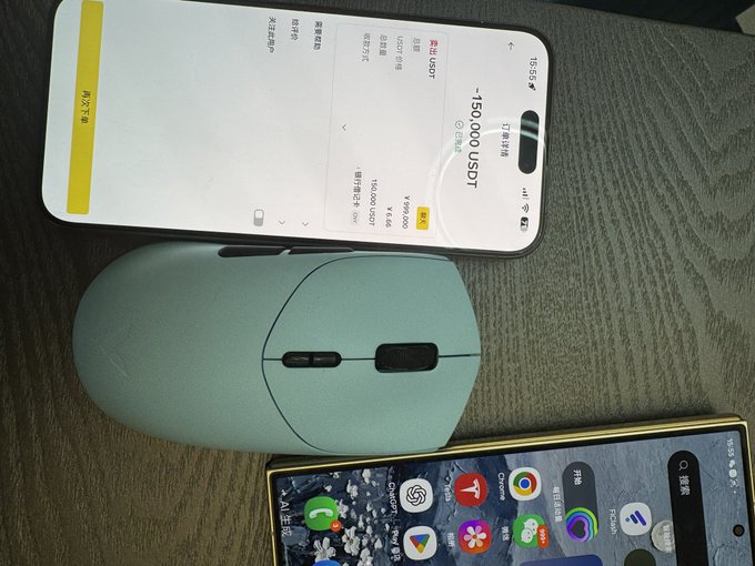 The image shows a light green Logitech MX mouse on a wooden surface, with a smartphone displaying a USDT withdrawal of -150,000 USDT from OKX, and another phone showing an app drawer—visually representing the "Ox to earn #BNB" crypto trading setup.