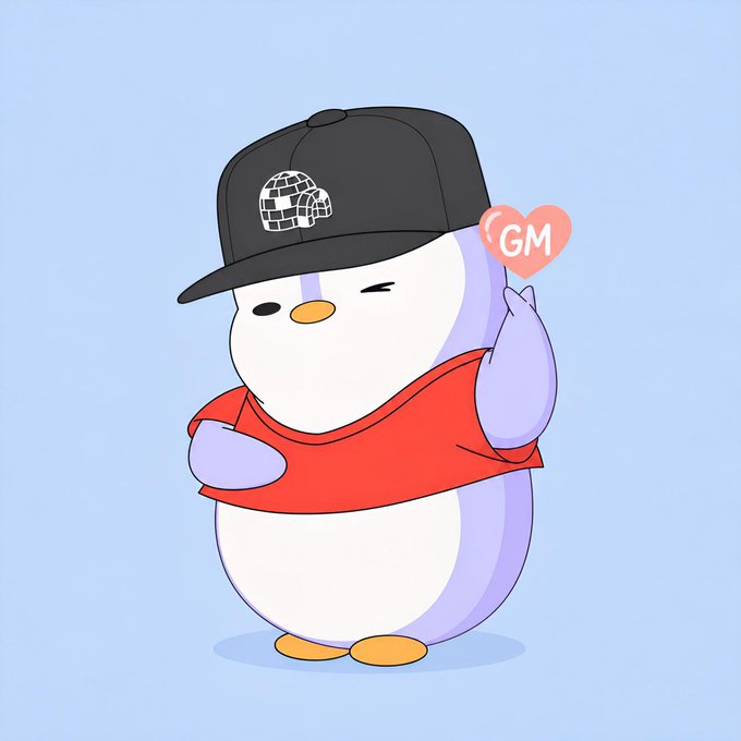 A cartoon penguin character wearing a black cap with a globe design and a red shirt winks and holds up a small pink heart reading 'GM'.