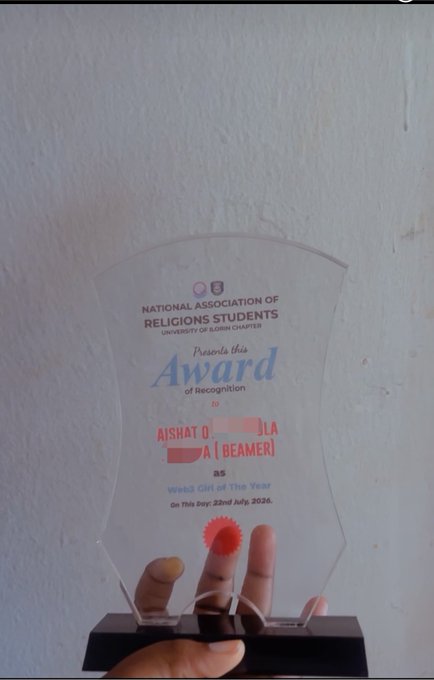 A hand proudly holds a clear glass award from the National Association of Religious Students (NARS) at the University of Ilorin Chapter, recognizing Aishat D. (Beamer) as the "Web3 Girl of the Year" on 22nd July, 2026. The caption celebrates this departmental recognition as a well-deserved honor.