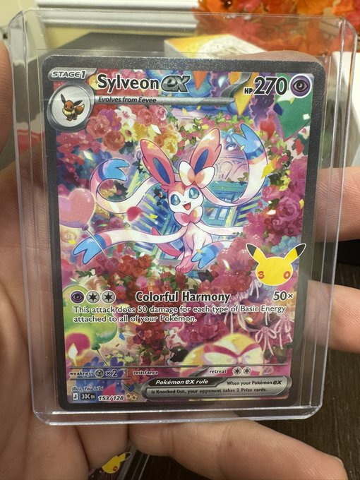 A hand proudly displays a holographic Pokémon TCG card featuring Sylveon ex (HP 270) with the "Colorful Harmony" attack, showcasing vibrant artwork surrounded by flowers and a Pikachu cameo that justifies the "Incredible art!" caption.