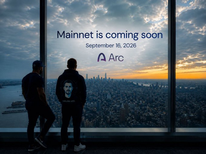 A promotional image showing two people looking out a window at the New York City skyline at sunset, announcing 'Mainnet is coming soon - September 16, 2026' for the Arc blockchain.