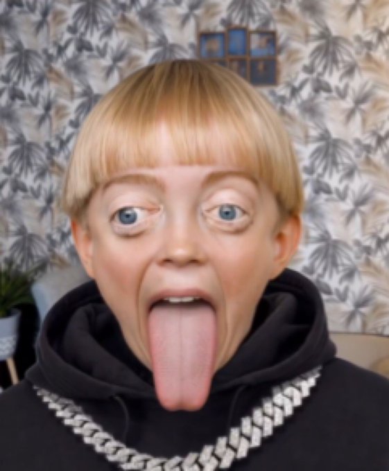 The image features a person with blonde hair making an odd face for the camera while sticking out their tongue. The photo has been edited to make the person appear as if they have a large nose or a big mouth, adding to the unusual appearance. The caption of the image reads "i put $1,000 into the LAB presale and it' s now worth $17,000,000". This statement is likely meant to be humorous, as the original price tag for the item in question was $1,000.