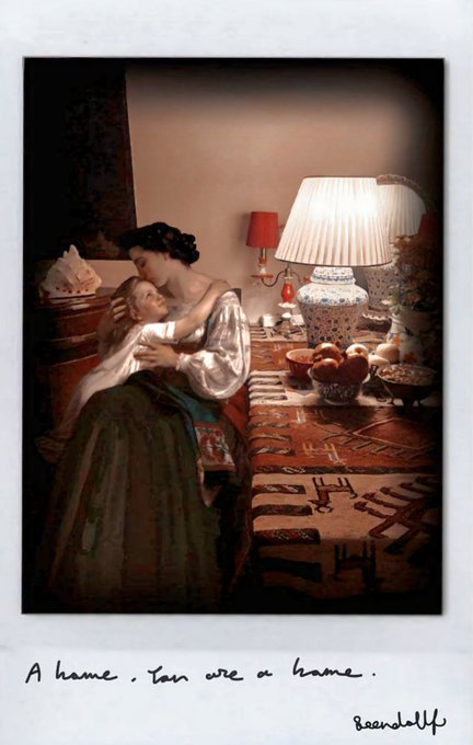 A Polaroid-style image shows a tender moment between a dark-haired woman and a blonde child, embracing in a warmly lit room with a vintage lamp and decorative table, accompanied by the handwritten text "A home. You are a home." signed "Barandolph" — visually echoing the post's reflection on womanhood as a nurturing, central presence.