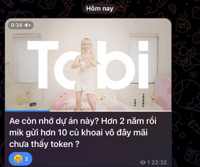 A social media post featuring a video thumbnail with "Tobi" text over a girl in white clothing, with Vietnamese text asking about a project and missing tokens after 2+ years.