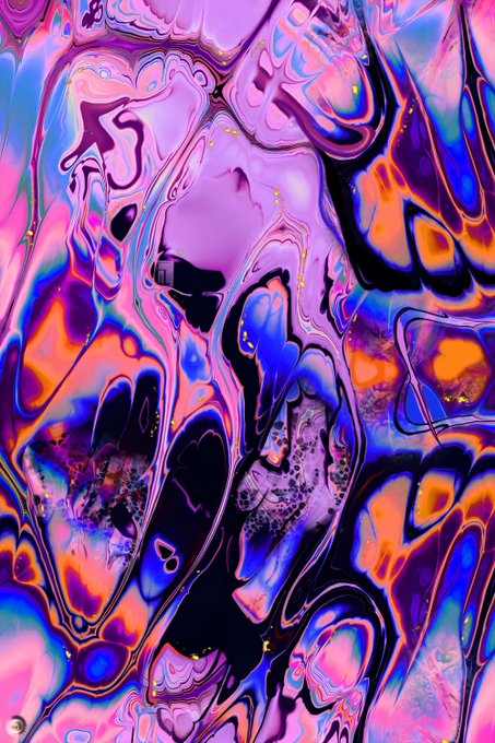 An abstract, fluid, psychedelic artwork featuring swirling patterns in vibrant hues of purple, blue, pink, and orange, with a watermark in the bottom left corner.