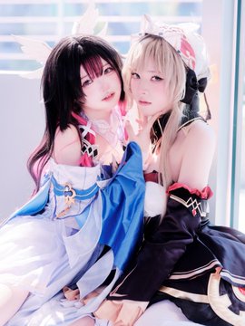 Two cosplayers pose closely together—one in a white and blue dress with fox-like ears and dark hair, the other in a black and red outfit with a hood and blonde hair—portraying the characters Sandrone and Columbina from Genshin Impact, fitting the "#sandbina" tag that references their ship name.