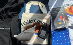 The image shows a collection of items, including a black hoodie with the words "WalletConnect" written on it, a white bag, an open book titled "The State of Digital Money", and a small stuffed animal. The objects are arranged in a way that suggests they belong together or are related to the concept of digital money. The post seems to be discussing the benefits of using WalletConnect for managing digital assets, such as wallets and apps, and how it can provide a seamless experience between different platforms.