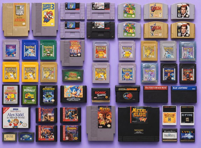 A collection of classic retro video game cartridges arranged on a purple surface, including titles like 'Super Mario Bros 3', 'The Legend of Zelda', 'Pokémon', 'Double Dragon', 'Sonic', and 'Metal Slug'.
