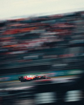 A Red Bull Formula 1 car speeds past blurred grandstands during practice for the #DutchGP, capturing the breakneck pace the post describes—mirroring how quickly both Bitcoin surging to 79K and the race day flies by.
