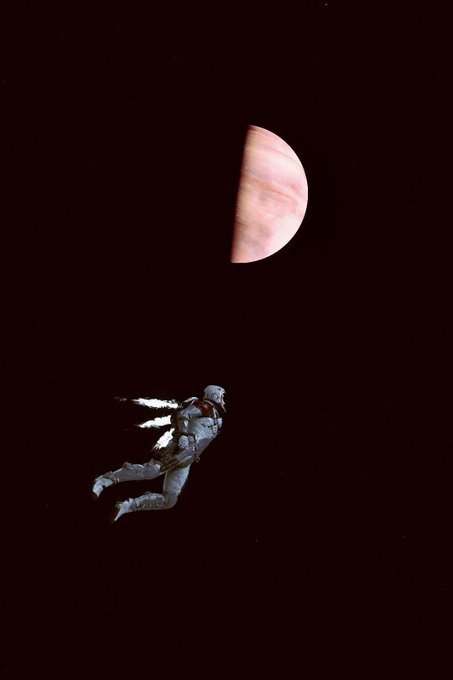 Artistic photo showing a person in a spacesuit floating in dark space near a large planet (possibly Jupiter), with visible jet propulsion exhaust.