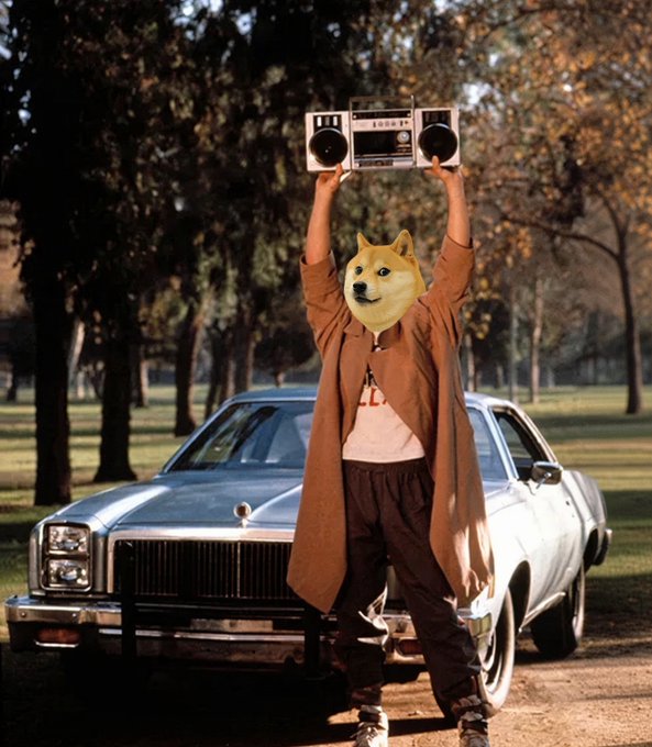 A figure wearing a Shiba Inu (Doge) mask triumphantly holds a vintage boombox above their head while standing in front of a classic American car, channeling iconic 80s hip-hop energy to celebrate the $DOGE pump mentioned in the caption. The "1" displayed on the boombox visually reinforces the "one dollar song" reference, tying the meme's nostalgic vibe to the bullish crypto sentiment.