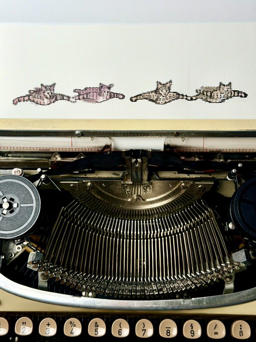 A vintage typewriter with visible keys (including numbers 2-9 and symbols like &, %, +, !) sits below a sheet of paper featuring four whimsical sketches of cats lying on their backs. The "wip" (work in progress) caption suggests the artist is still developing this charming illustration series of the feline figures.