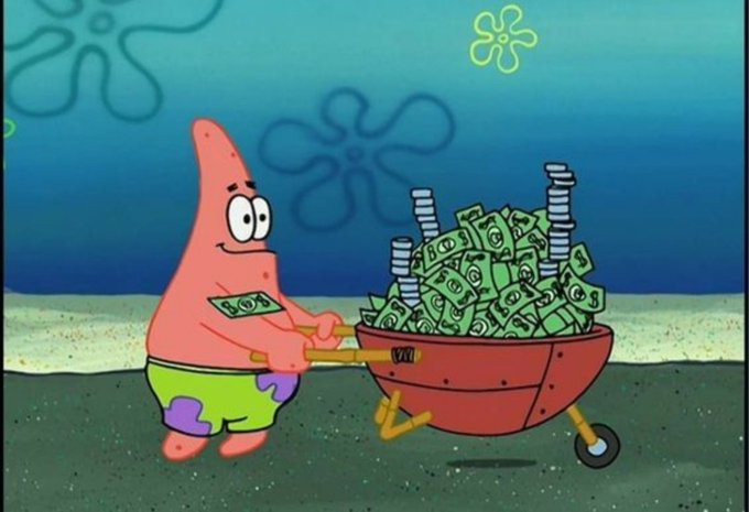 Patrick Star pushes a wheelbarrow overflowing with dollar bills, symbolizing wealth accumulation. The meme caption "Hope you're still locked in?" humorously pairs with the image to mock or encourage long-term holding of investments.