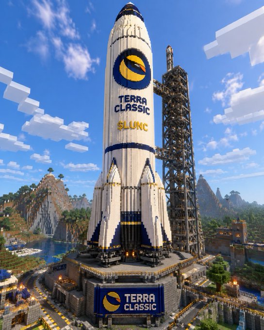 A massive, intricately built Minecraft rocket branded with "TERRA CLASSIC" and "$LUNC" stands tall on a detailed launchpad, towering over the surrounding blocky landscape. The creation visually represents the post's title, showcasing a giant tribute to the Terra Classic cryptocurrency ($LUNC) within the game.