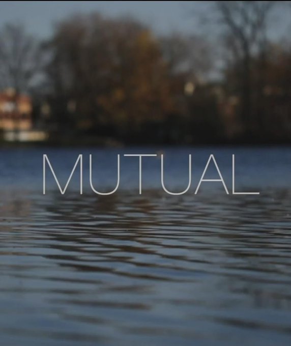 A serene lake scene at dusk with the word "MUTUAL" displayed prominently in white text across the center.