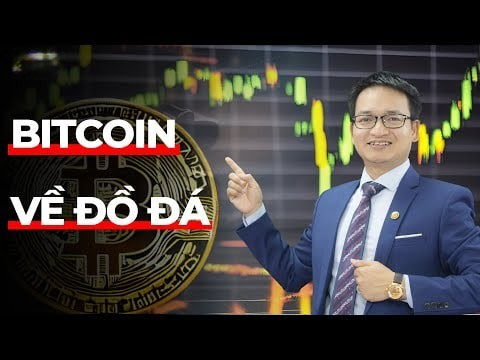 The image features a man dressed in a suit standing next to a large Bitcoin symbol. The man appears to be giving a speech or presentation, with his hand raised as if he's pointing at something. The Bitcoin symbol is prominently displayed on the left side of the frame, and there are text elements surrounding it that read "Bitcoin about stone age sit down here let me tell you about a legend kkk every time the old man sticks his head in, Cụt thinks of this legend last season, y'all were probably no strangers to this idol don't know if the idol still watches BTC now y'all still remember". The overall atmosphere suggests that the image is related to a video or presentation about Bitcoin and its history.