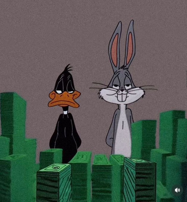 Daffy Duck and Bugs Bunny stand side by side in front of tall stacks of green cash, both looking melancholy.