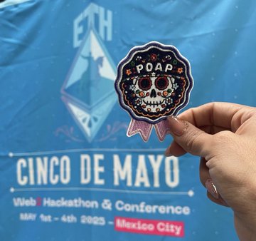 A hand holding a Day of the Dead sugar skull POAP badge in front of a blue banner for 'ETH Cinco de Mayo Web3 Hackathon & Conference' held May 1st-4th, 2025 in Mexico City.