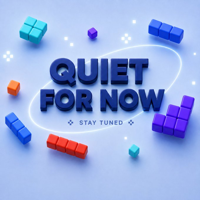 A 3D-rendered graphic with blue lettering reads 'QUIET FOR NOW' with 'STAY TUNED' below, surrounded by colorful Tetris-like blocks (red, blue, purple, teal) on a light blue background.
