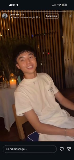 Instagram story screenshot from user 'gunna B' at 4:31 showing a smiling young man in a white t-shirt sitting in a chair at a candlelit outdoor setting with bamboo in the background.