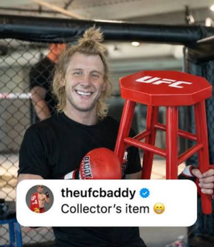 Photo of a smiling young man with a mullet holding a red UFC stool inside an octagon, posted by the Instagram account 'theufcbaddy' with the caption 'Collector's item 😮'.