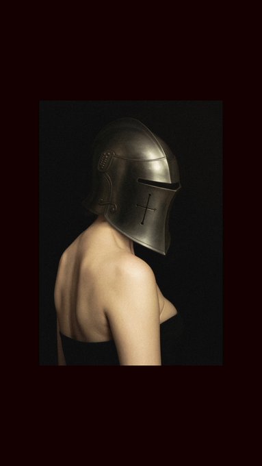 A person wearing a medieval metal helmet with a cross etched on it, their back turned to the camera, embodying the post's message of standing out as a rational, sense-making minority in an irrational world. The image evokes a sense of armored solitude and defiance, visually reinforcing the call to "fight for the 1% that still makes sense."
