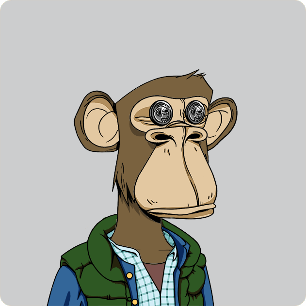The image features a cartoon monkey wearing a green vest, blue shirt, and jacket with goggles on its eyes. The monkey appears to be looking off into the distance or posing for the camera. The background of the image is gray, which contrasts with the vibrant colors of the monkey's outfit. There are no other objects in the image besides the monkey itself.