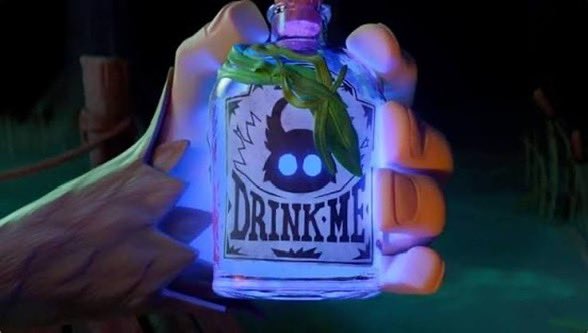 A close-up of a gloved hand holding a glowing glass bottle labeled 'DRINK ME', featuring a black horned silhouette and adorned with green leaves, reminiscent of a video game asset.