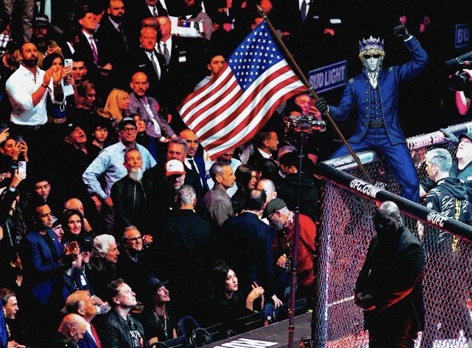 The image shows a man standing next to an American flag, with a crowd of people surrounding him. In the background, there are several men wearing suits and ties, suggesting that they might be political figures or part of a formal event. The caption "PATRIOTS IN CONTROL" implies that the crowd is supporting a particular cause or individual, possibly related to politics or social issues.

The image also contains text that reads "PATRIOTS IN CONTROL". This phrase could be interpreted as an expression of solidarity with a specific group or cause, and it might be connected to the man standing next to the American flag in some way.