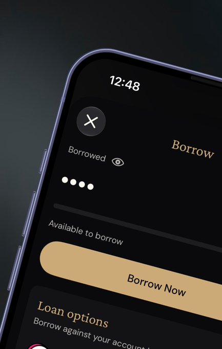 A close-up of a smartphone displaying a financial app interface with a 'Borrow' screen showing 'Borrowed' status, 'Available to borrow' section, and a gold 'Borrow Now' button.