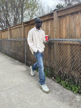 A man wearing a beanie, sunglasses, white jacket, jeans, and white sneakers walks along a sidewalk beside a wooden fence, holding a red cup. The image complements the post's message about advocating for transparency and accountability in NFT projects, with the man's casual stroll symbolizing a moment of reflection after turning down a promotional opportunity due to ethical concerns.