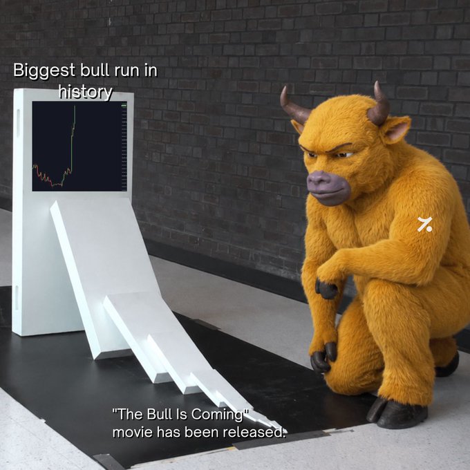 The image shows a menacing, furry bull figurine crouching next to a stock chart displaying a sharp decline, with text reading "Biggest bull run in history" above and "'The Bull Is Coming' movie has been released" below.

The post's claim of "no news or catalyst" is humorously contradicted by the image, which sarcastically suggests the massive bull run itself—with its dramatic chart shown—is the catalyst, humorously framed as an unstoppable force like a bull movie coming to theaters.