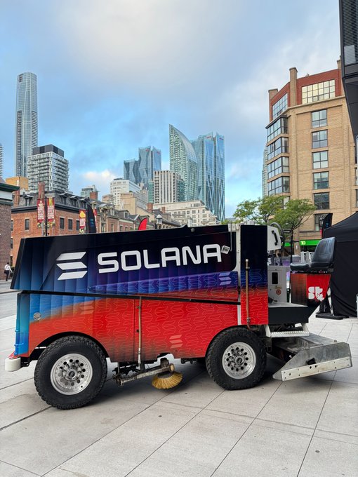 Zamboni ice resurfacer branded with Solana's logo and name parked outdoors with a city skyline in the background.
